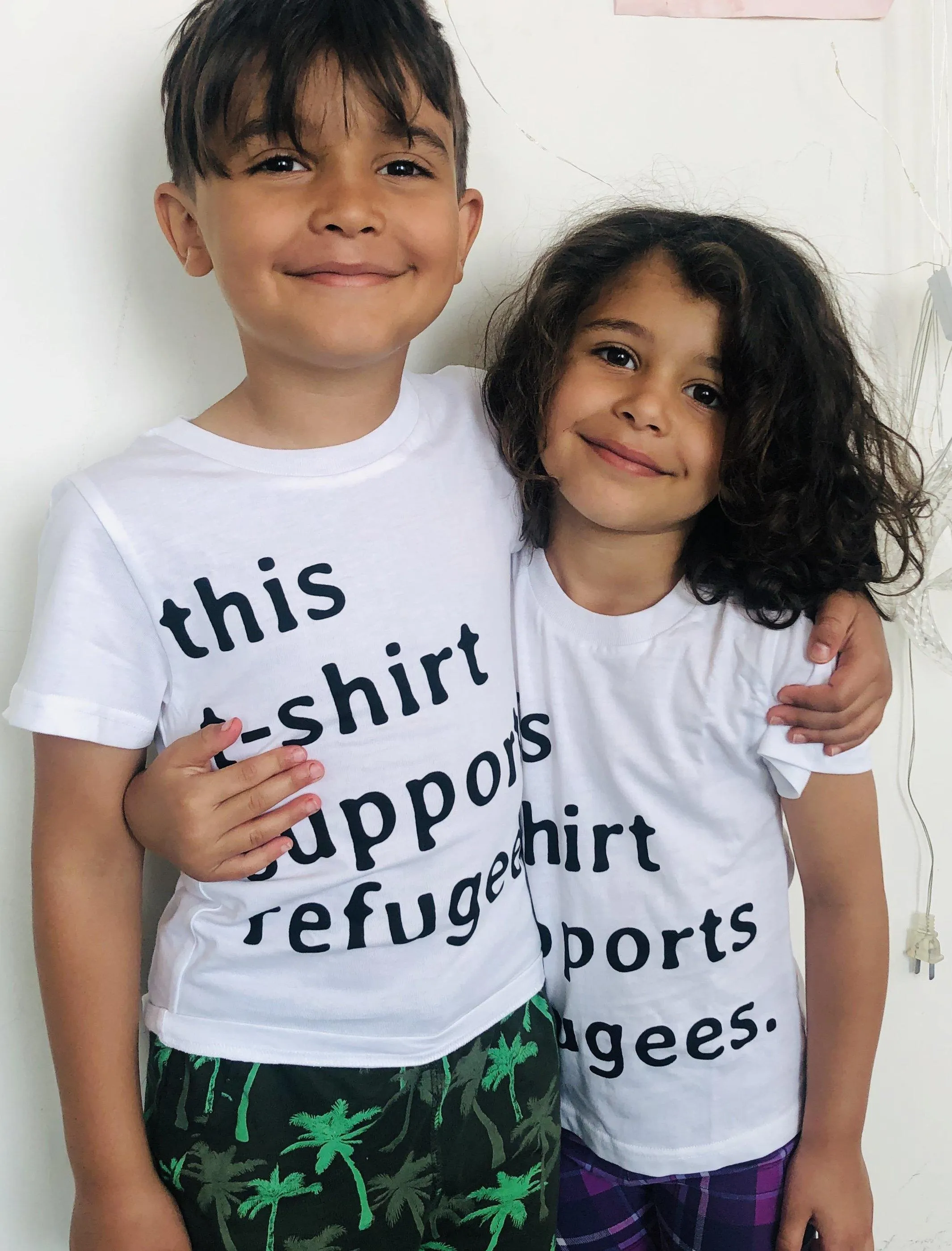 Sitti x UNHCR: "this t-shirt supports refugees." Unisex T-Shirt.