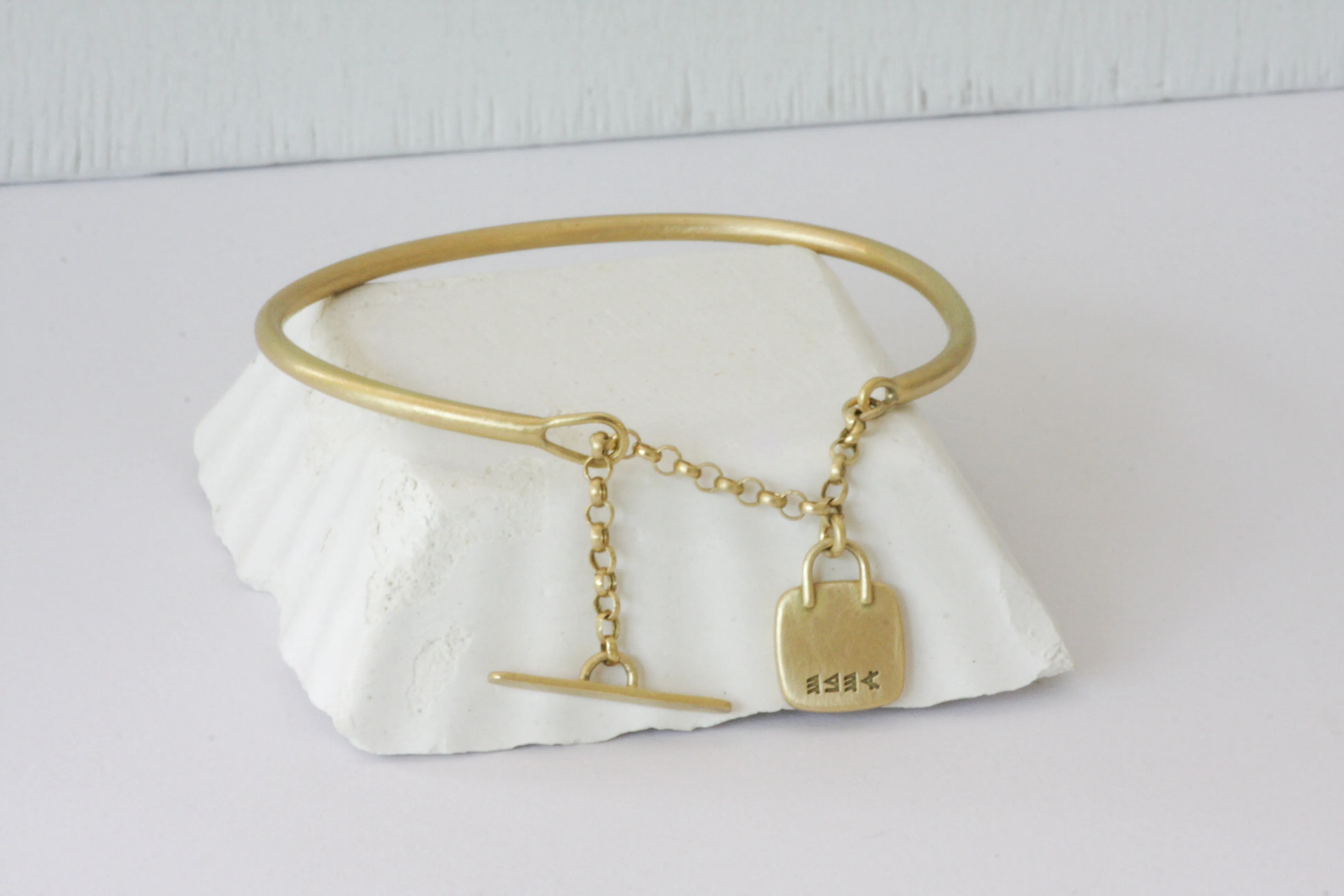 Solid Gold Open cuff bracelet with chain closure