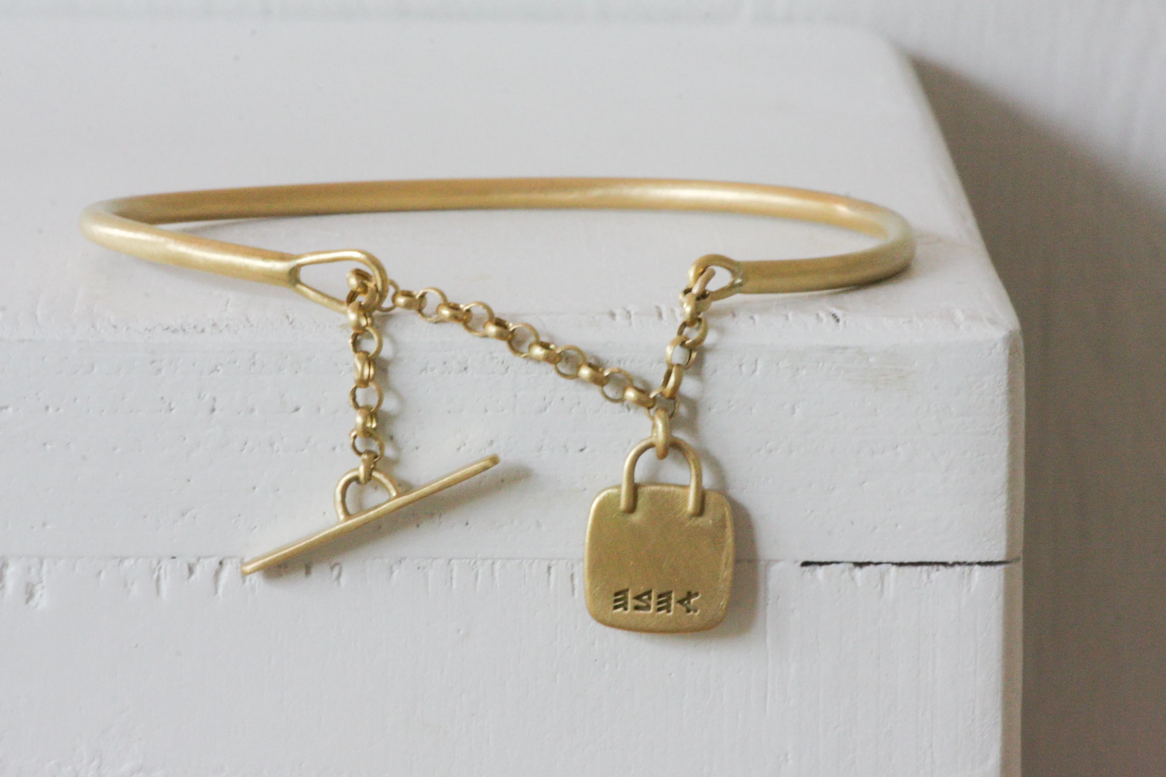 Solid Gold Open cuff bracelet with chain closure