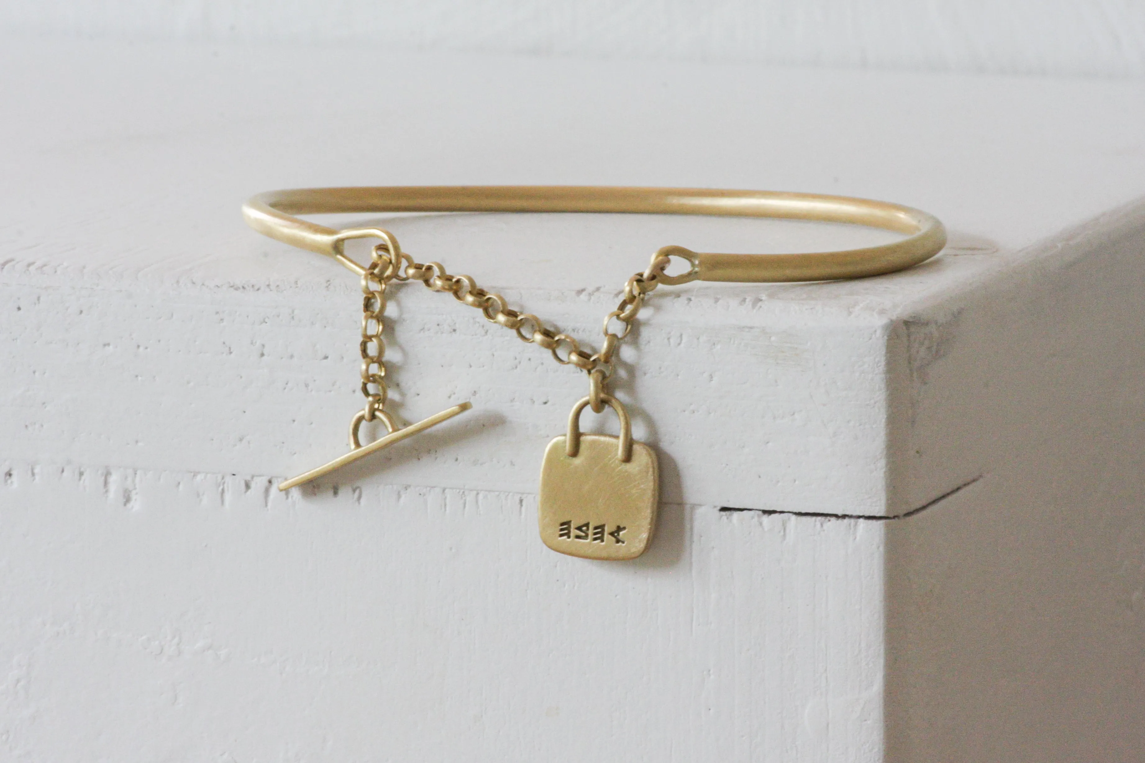Solid Gold Open cuff bracelet with chain closure